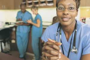 Nurses in nurses station charting and thinking about patient load