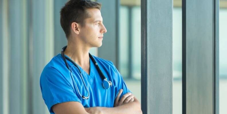 Male Nurse Looking out Window