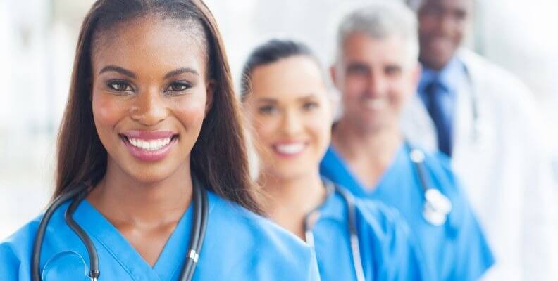 Registered nurse in front of additional medical staff