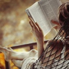 Woman_Relaxing_Reading_In_Hammock