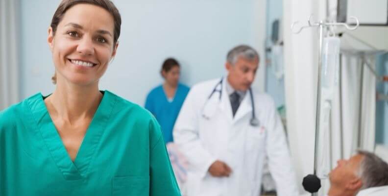 Nurse in Foreground and Doctor with Patient in Background